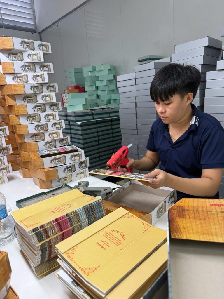 Làm mẫu hộp quà Tết tại xưởng — công nhân dán và hoàn thiện hộp cứng Golden Box